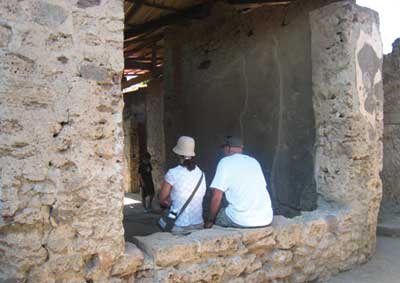 Visitors resting in the shade-without clear communication, they are unaware of the impacts of their actions on the conservation of the site (Pompeii)