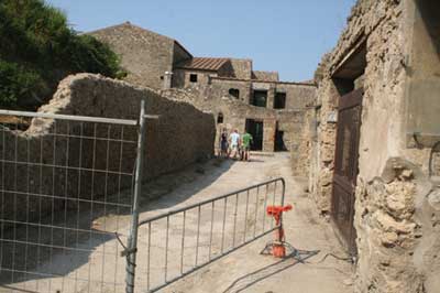 isitors by the House of the Meander. The barricades in the foreground had been moved by the visitors to get access to the house, which was closed for restoration at the time of this photograph (Pompeii).